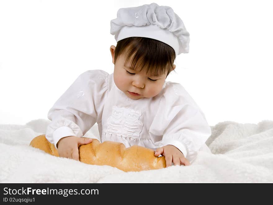 Little baby is sitting and holding bread. Little baby is sitting and holding bread