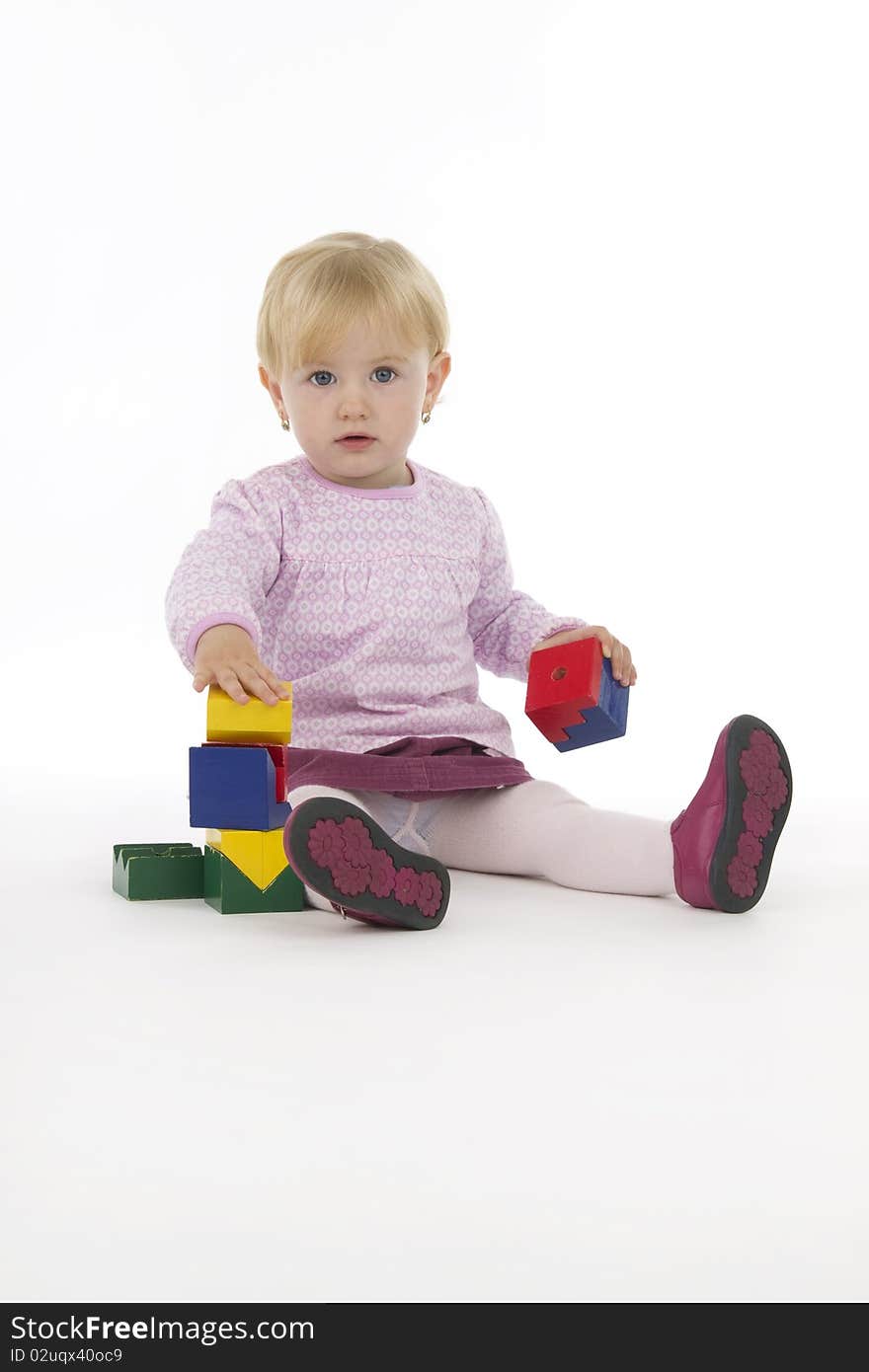 Little girl with wooden cubes, on white background. Little girl with wooden cubes, on white background.