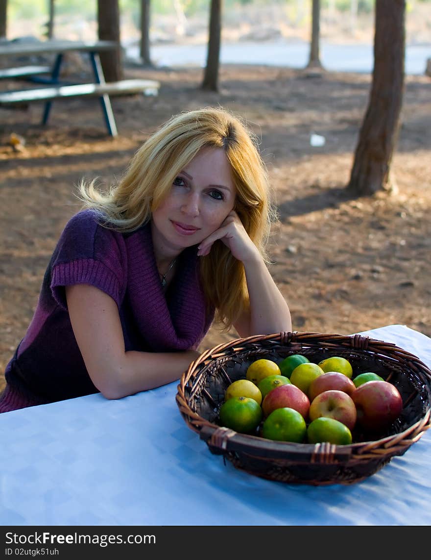 Young smiling woman with fruits . Young smiling woman with fruits .