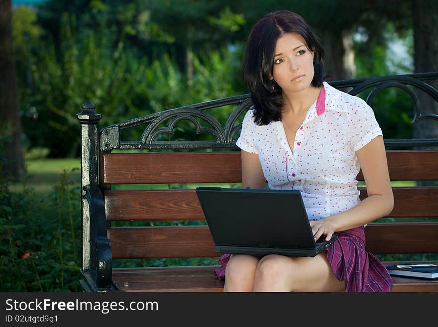 Girl with laptop in park