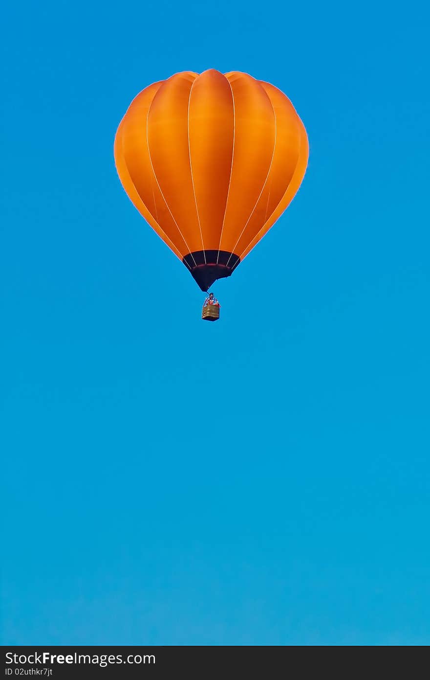 Orange balloon in blue sky