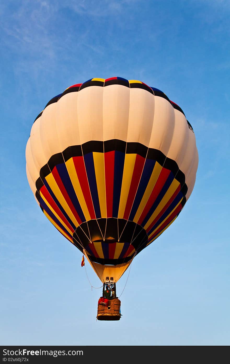 Colorful balloon in blue sky with two rider. Colorful balloon in blue sky with two rider