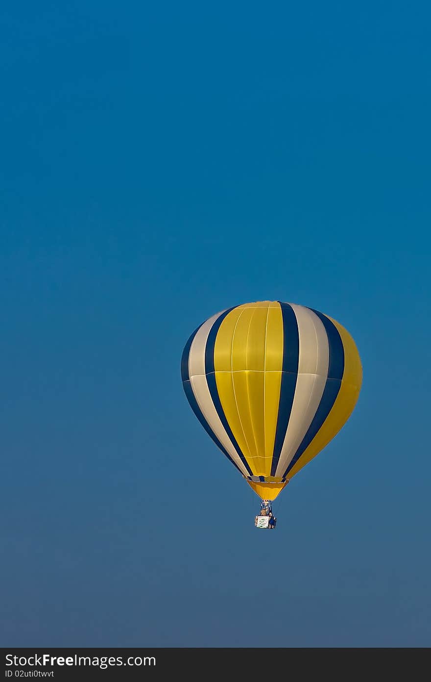 Colorful balloon in blue sky with two rider. Colorful balloon in blue sky with two rider