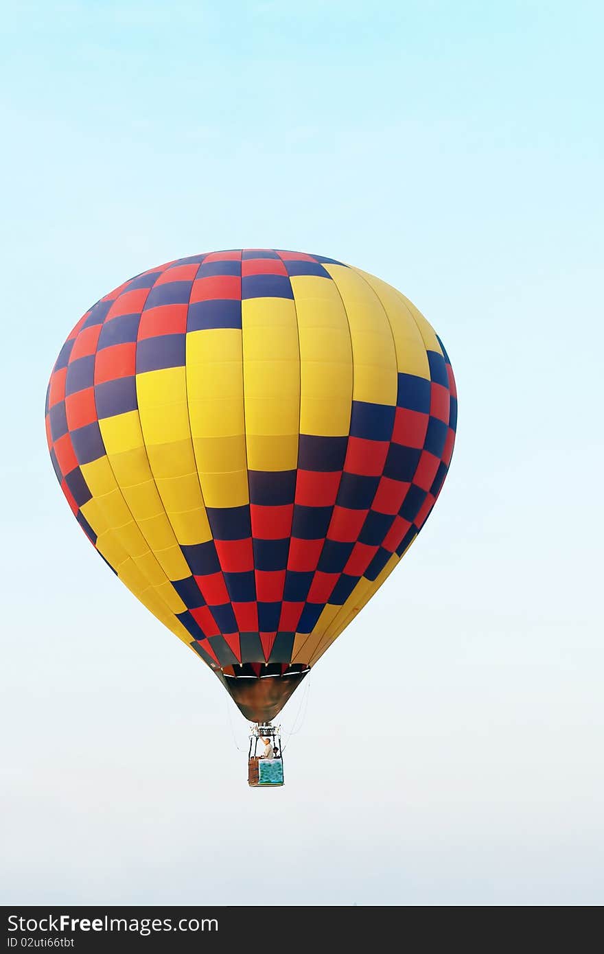 Colorful balloon in blue sky with rider. Colorful balloon in blue sky with rider