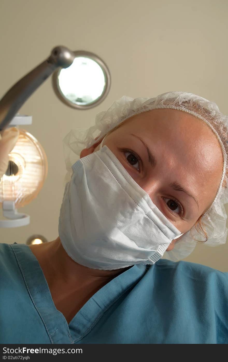 Image of female healthcare professional (doctor/nurse) wearing a surgical mask . Image of female healthcare professional (doctor/nurse) wearing a surgical mask .