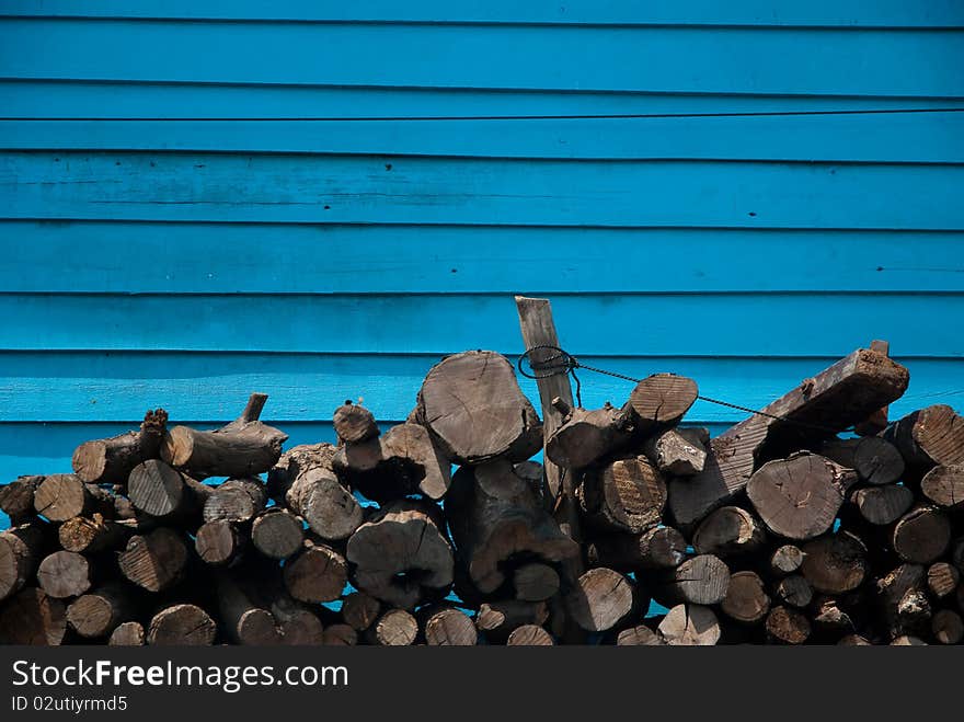 Fire wood on blue wall background