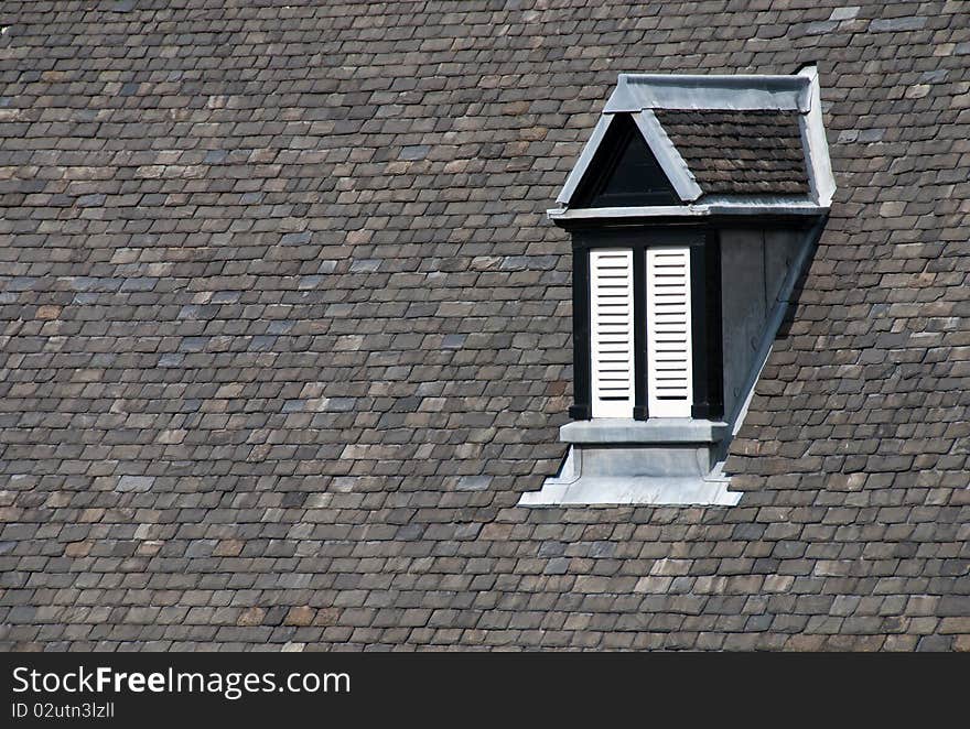 Roof of a house with attic window