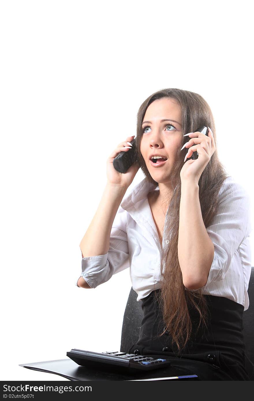 Surprised businesswoman speak by two phones