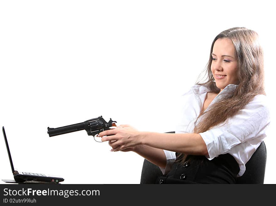 Businesswomen is aiming a revolver at a notebook