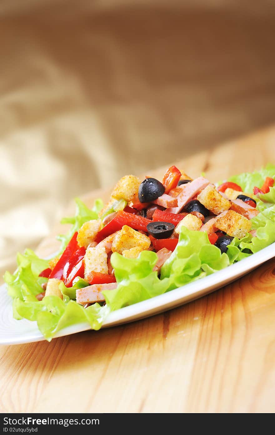 Fresh and tasty salad on plate, wooden table. Fresh and tasty salad on plate, wooden table