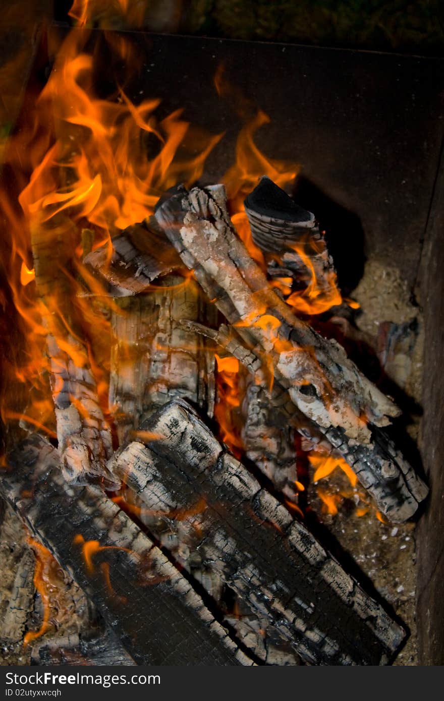 Burning wood in a fire close to making kebab. Burning wood in a fire close to making kebab