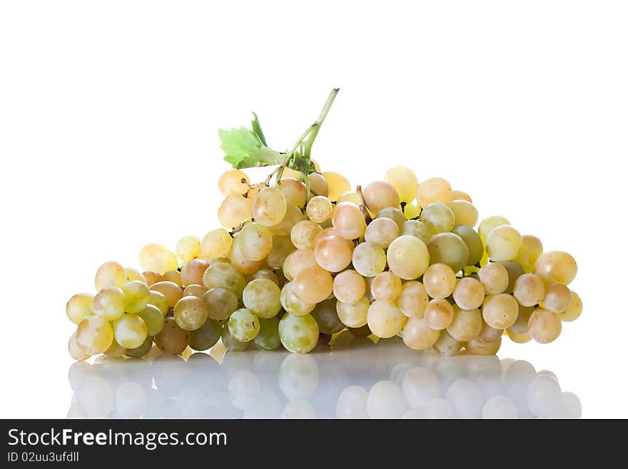 Fresh cut bunch of grapes with reflection isolated on white