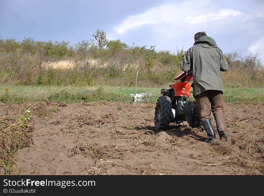 Farmer plowing the ground