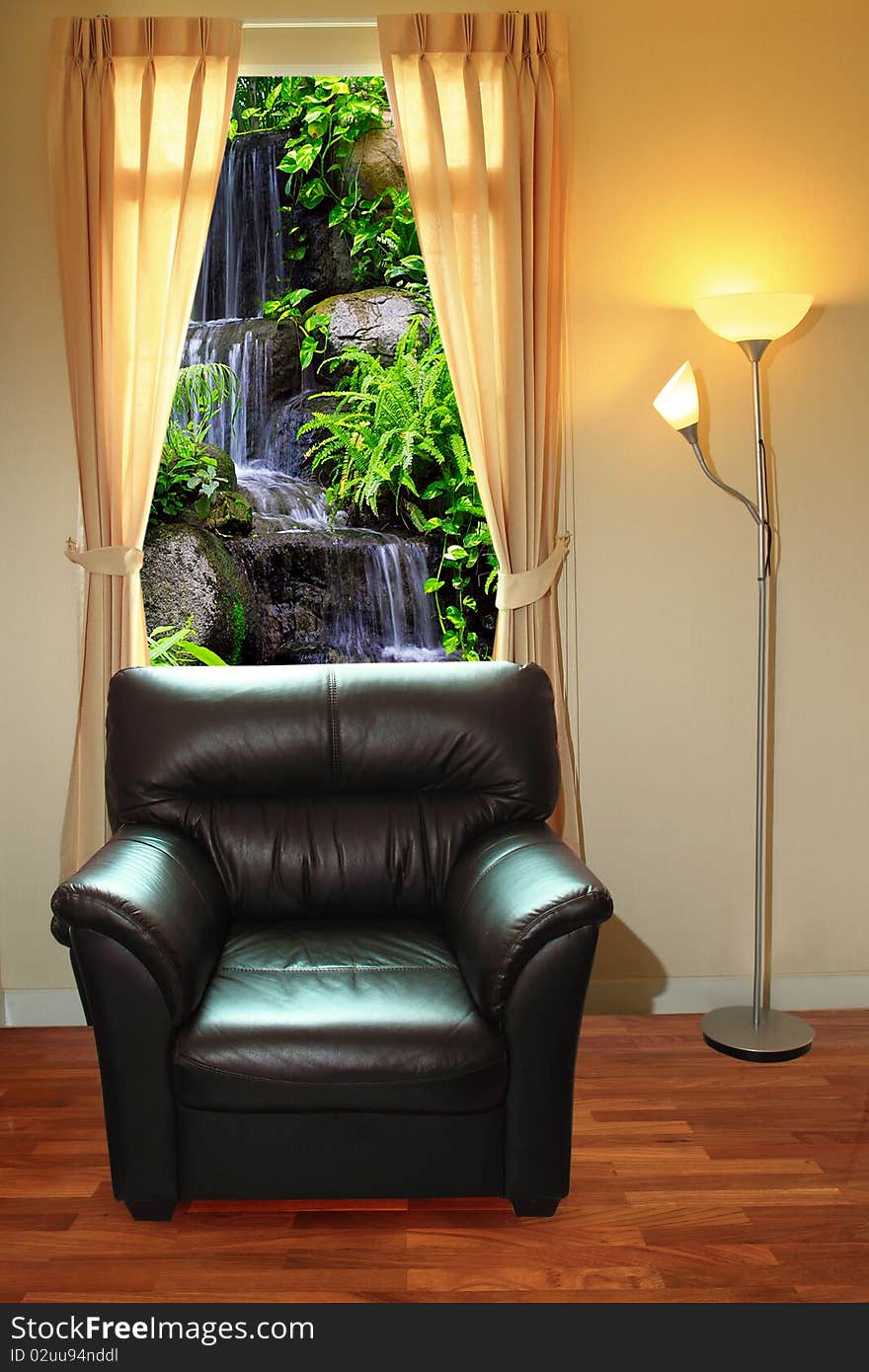 Black sofa and lamp in front of waterfall