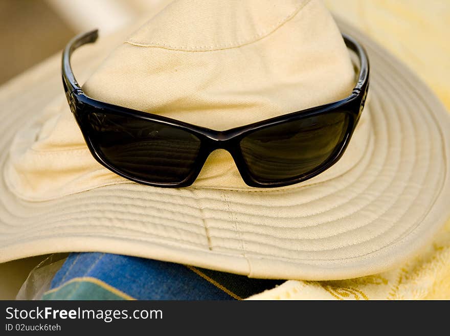 Hat and sunglasses on the beach. Hat and sunglasses on the beach