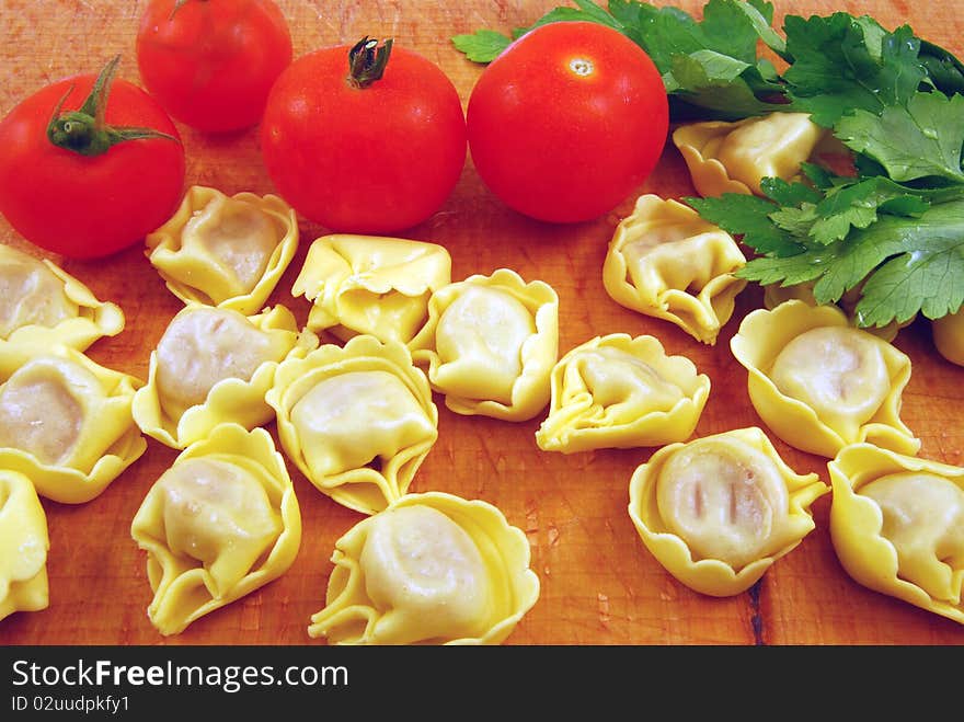 Prepare tortellini stuffed with meat sauce with tomato and parsley. Prepare tortellini stuffed with meat sauce with tomato and parsley