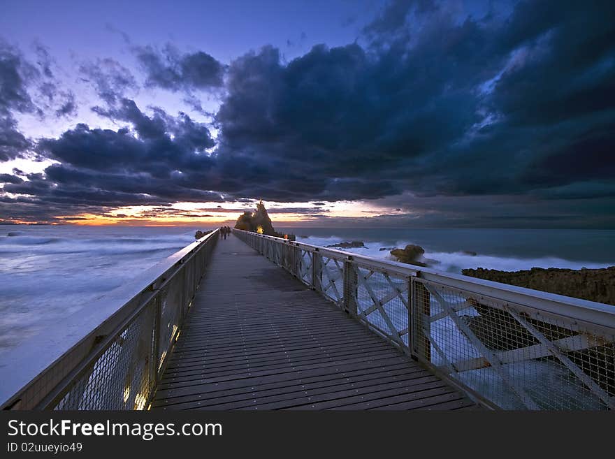 Biarritz and the Rocher de la Vierge during a sunset. Biarritz and the Rocher de la Vierge during a sunset