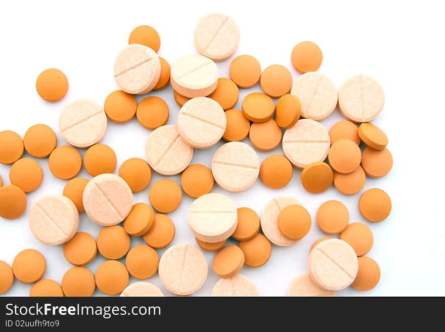 Orange and Pink medicine pills isolated on white. Orange and Pink medicine pills isolated on white