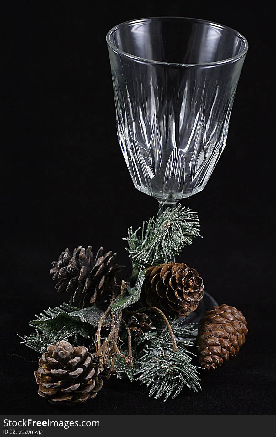 A glass with a branch of pine needles