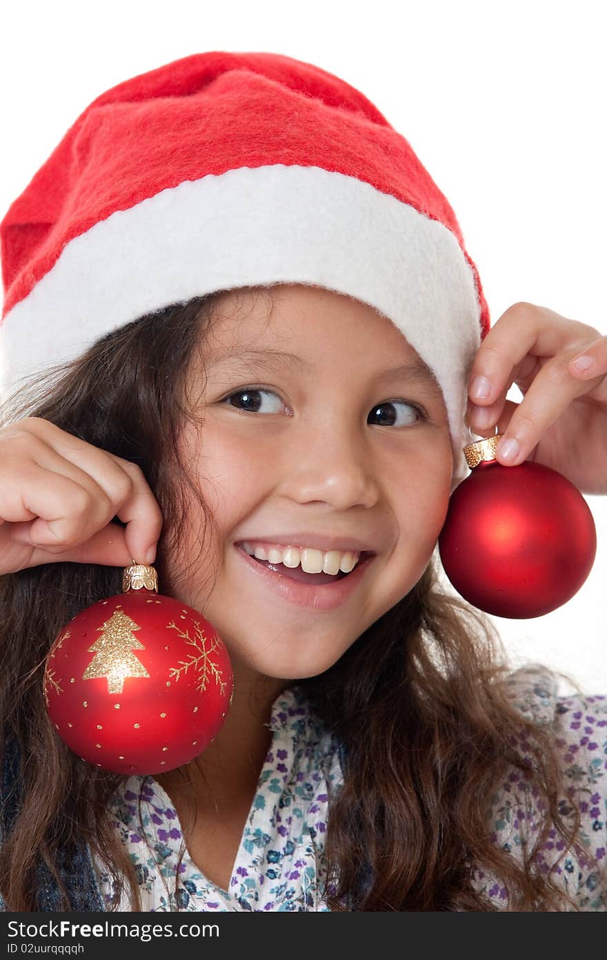 Christmas, charming child with Christmas bonnet and Christmas tree ball before white background