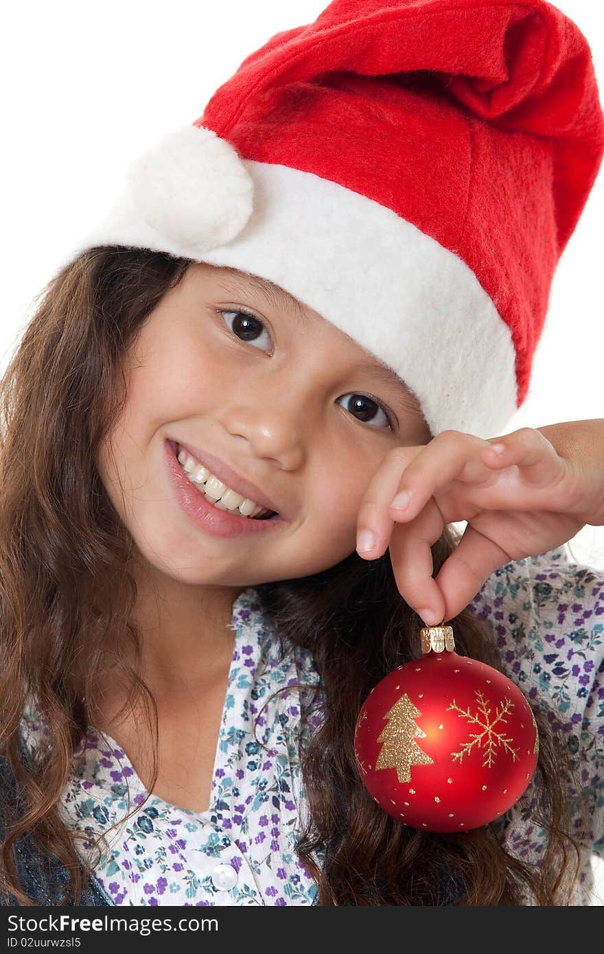 Christmas, charming child with Christmas bonnet and Christmas tree ball before white background