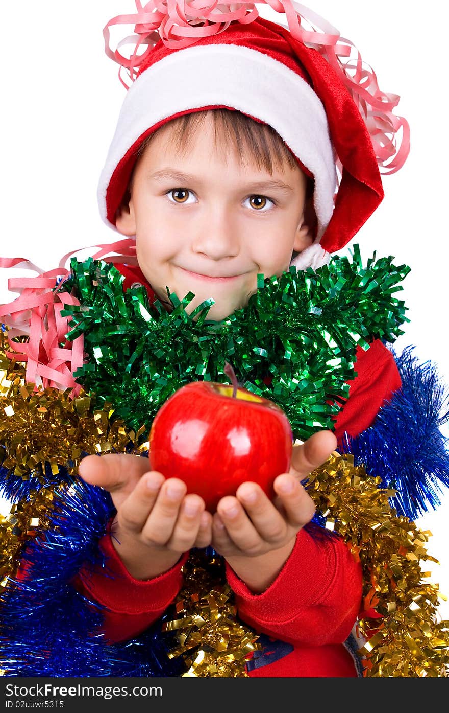 Cute small boy in santa's hat with apple in hands