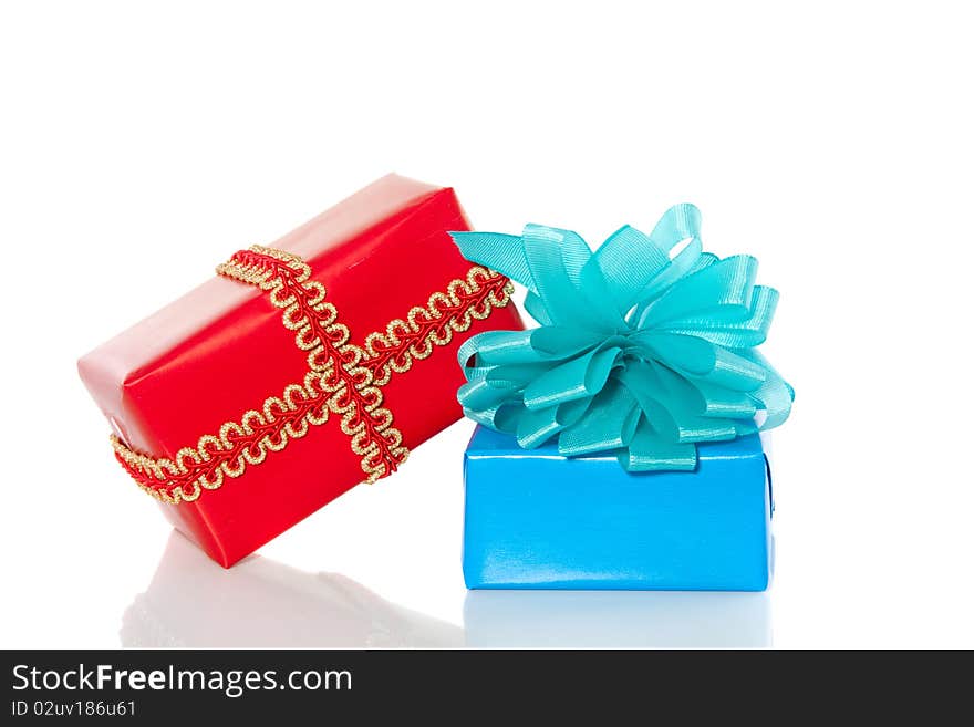 A red and a blue gift with a ribbon and a bow isolated over white