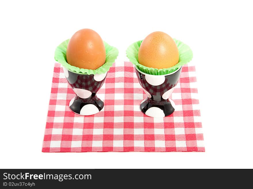 Two eggs in dotted eggshells  on a red white checkered napkin