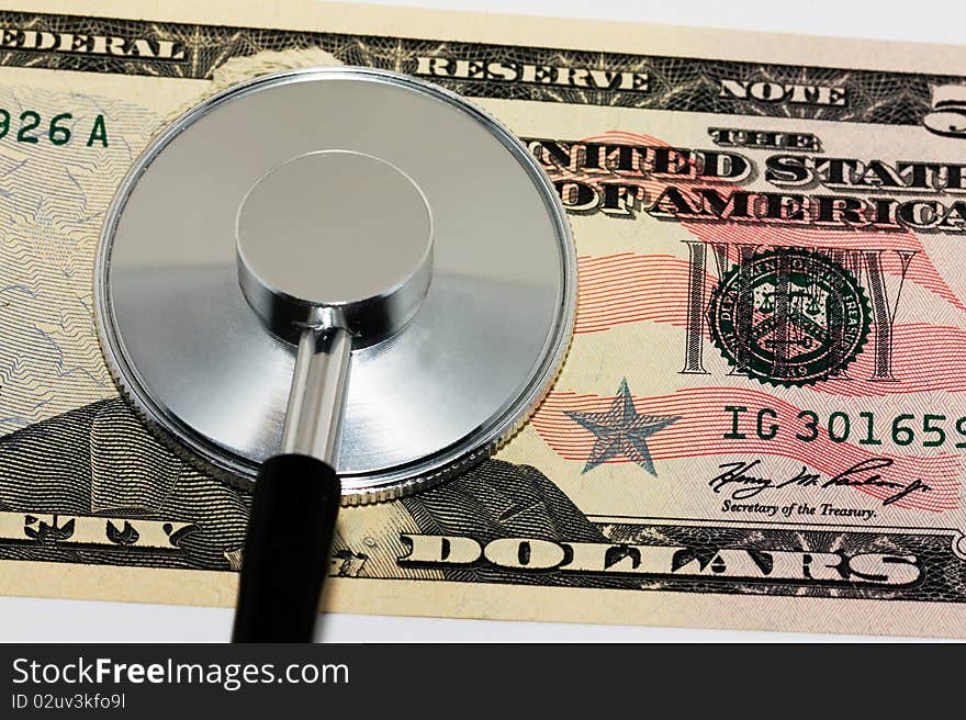 The American money (dollars) on which the stethoscope lies. The American money (dollars) on which the stethoscope lies