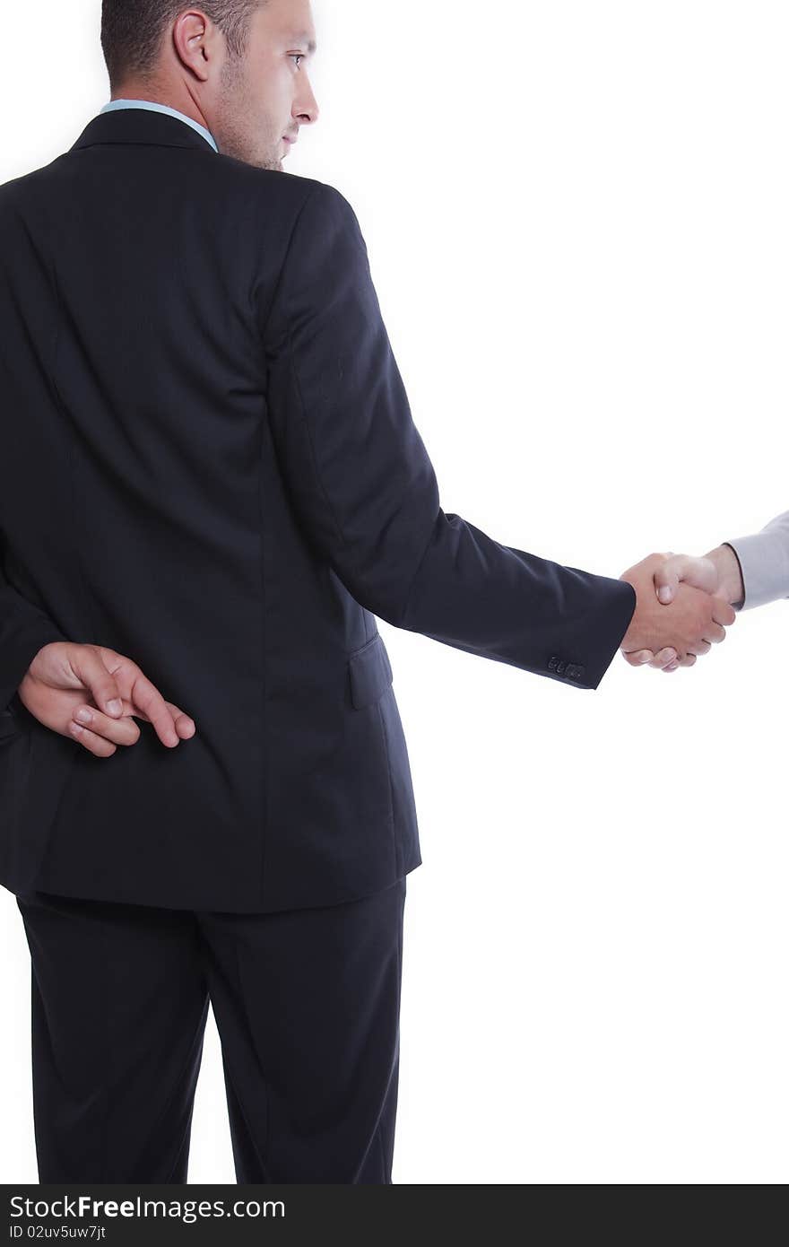 Businessman shaking hands, holding fingers crossed