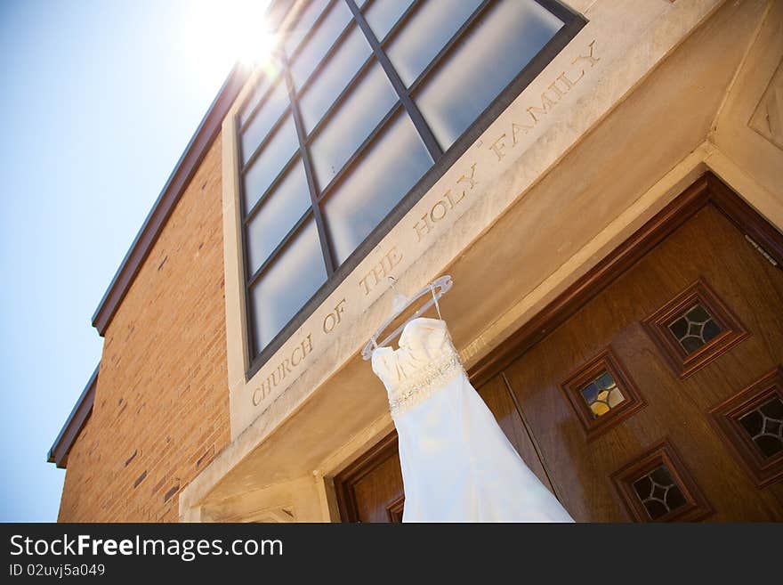 Ivory satin Wedding Dress Hanging on Church. Ivory satin Wedding Dress Hanging on Church