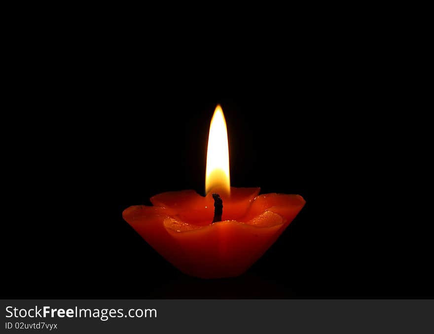 Red candle light in dark background