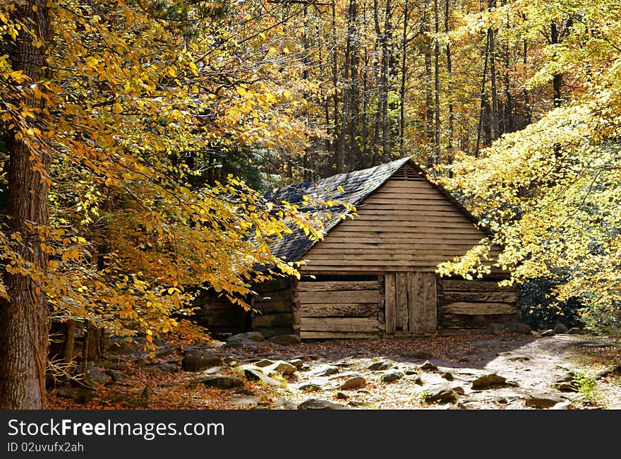 Rustic barn made of plank wood nested deep in the mountains surrounded by colorful autumn foliage. Rustic barn made of plank wood nested deep in the mountains surrounded by colorful autumn foliage