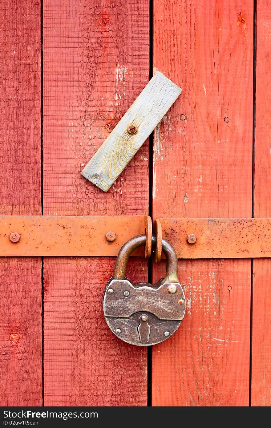 The padlock locking the wooden door