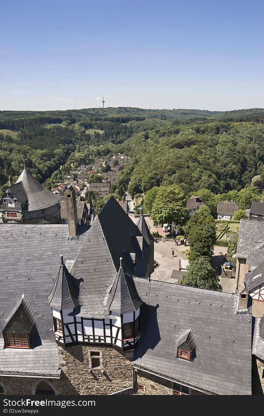 The view from the main tower of the fortress on the tower and part of the fortress wall. Perspective view of the valley of the river and the old town. Sunny morning. Schloss Burg. Germany. The view from the main tower of the fortress on the tower and part of the fortress wall. Perspective view of the valley of the river and the old town. Sunny morning. Schloss Burg. Germany.