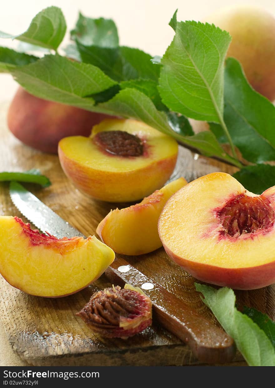 Fresh peaches on board with knife