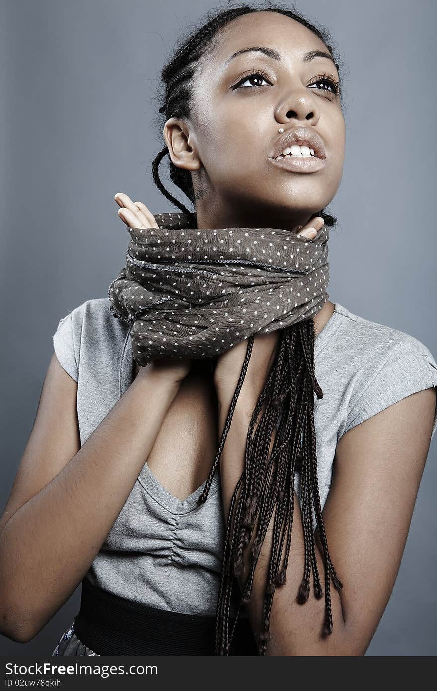 Beautiful African woman with natural make-up pose on grey background. Beautiful African woman with natural make-up pose on grey background.