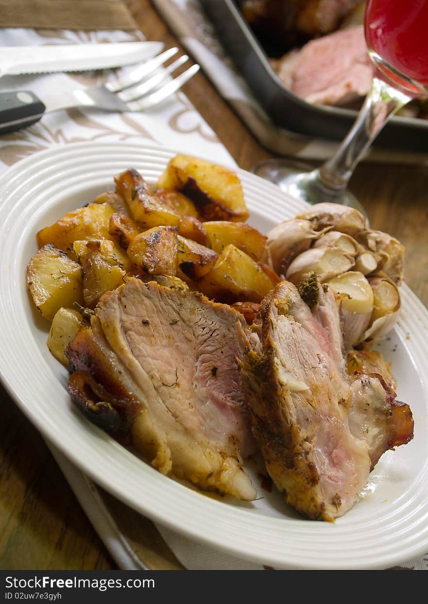 Delicious roasted pork knuckle with baked potatoes. Delicious roasted pork knuckle with baked potatoes