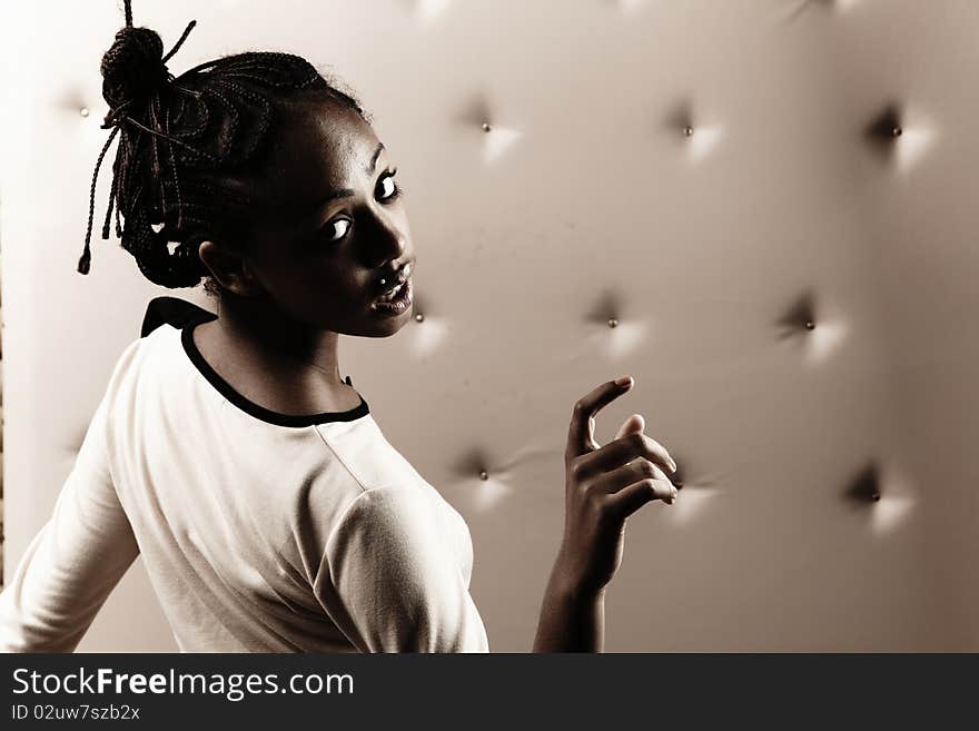 Close-up portrait of Beautiful African woman pose on a beige leather background.