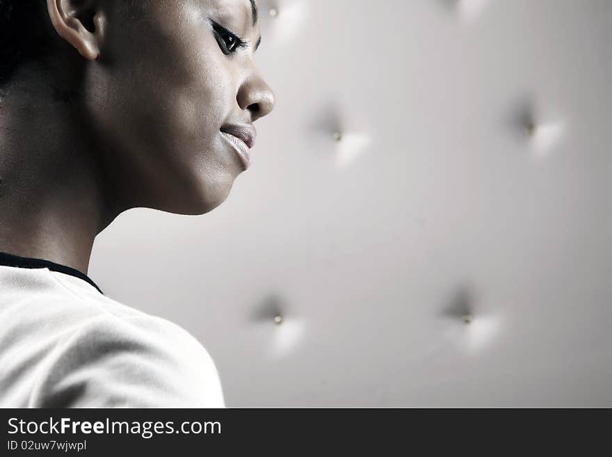 Close-up portrait of Beautiful African woman pose on a beige leather background.