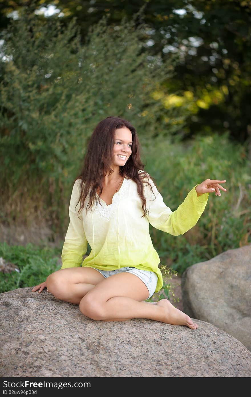 Woman sitting on stones