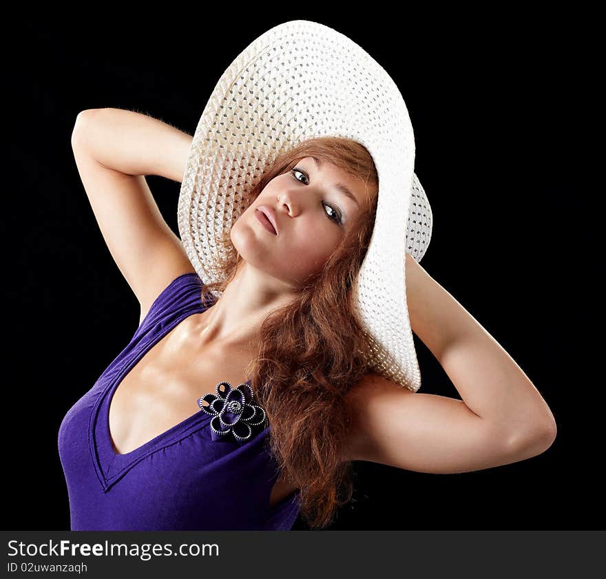 Girl in sexy dress with a hat isolated on black background