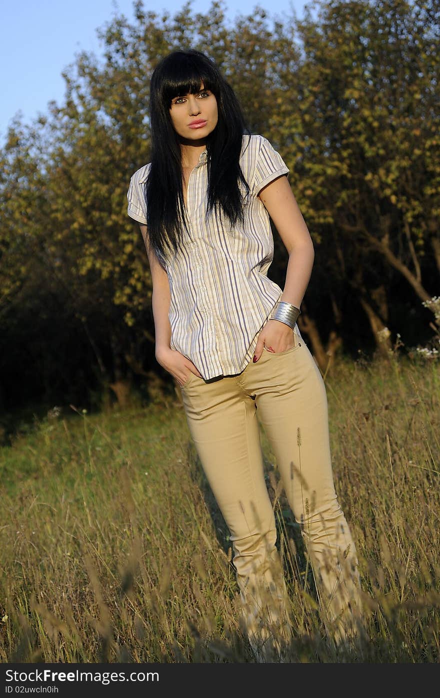 Young woman presenting bracelets and clothing. Young woman presenting bracelets and clothing