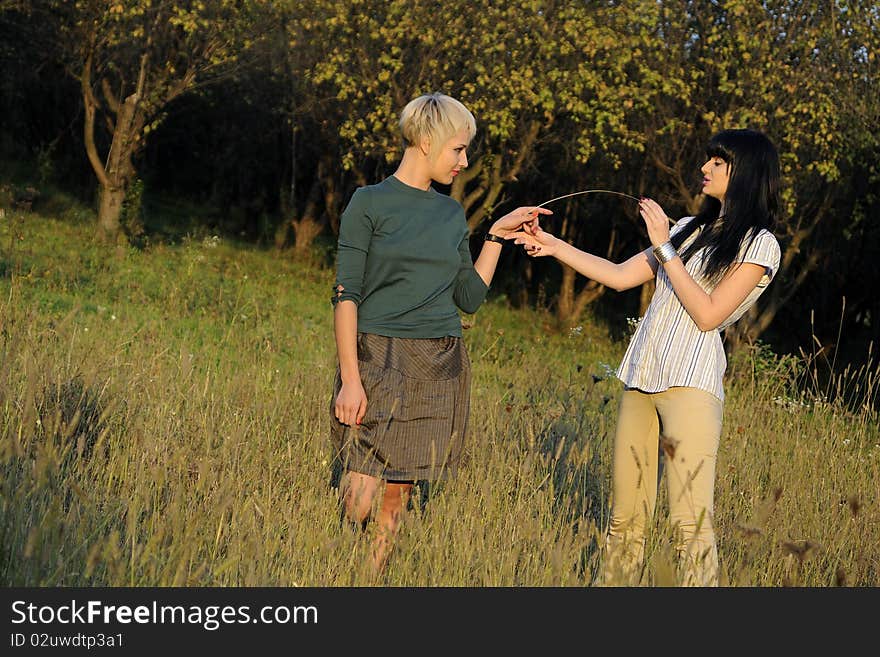 Beautiful teenager girls playing with plants in nature. Beautiful teenager girls playing with plants in nature