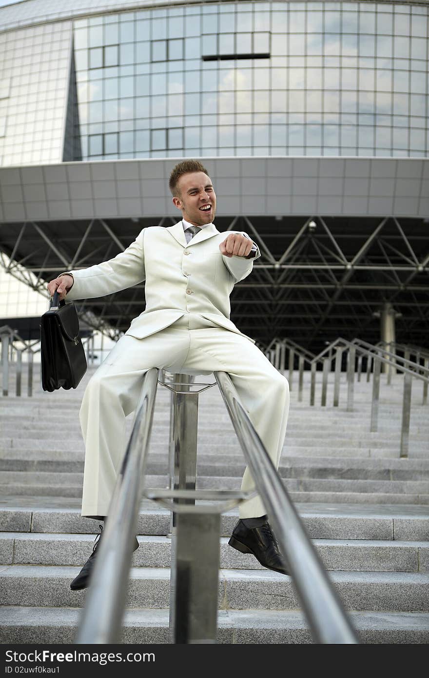 Handsome business man on the stairs reviewing his notes. Handsome business man on the stairs reviewing his notes