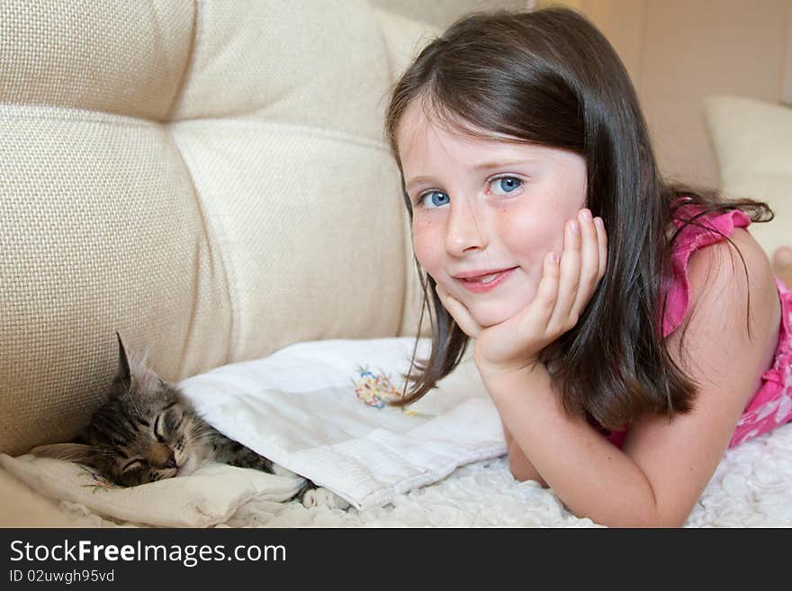 Pretty caucasian girl plays with a cat. Pretty caucasian girl plays with a cat