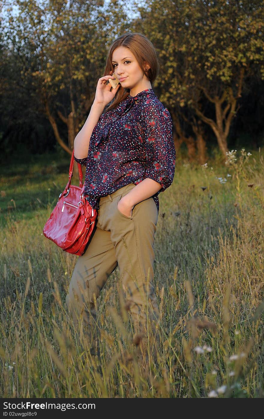 Teenager girl talking on mobile in nature. Teenager girl talking on mobile in nature