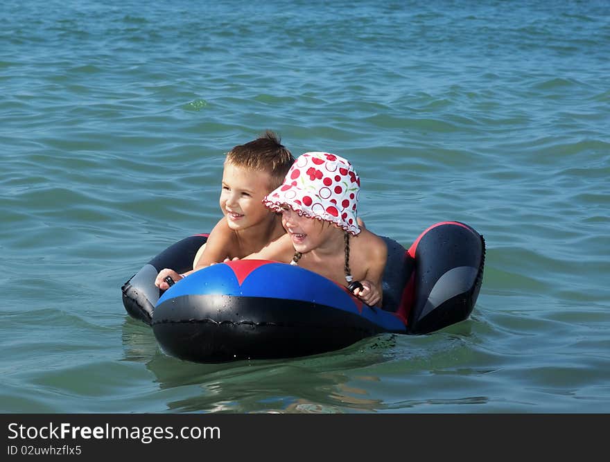 Boy and girl on sea mattress