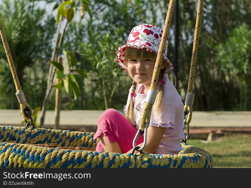 Little Girl Smiling on Swing