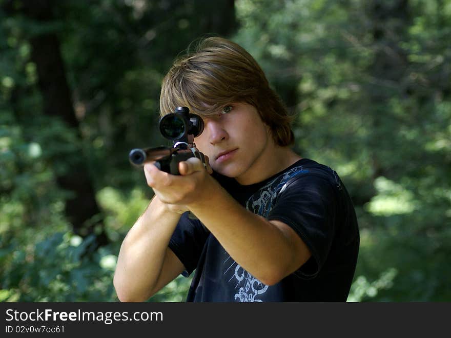 Fifteen years old boy with a gun in the forest. Fifteen years old boy with a gun in the forest